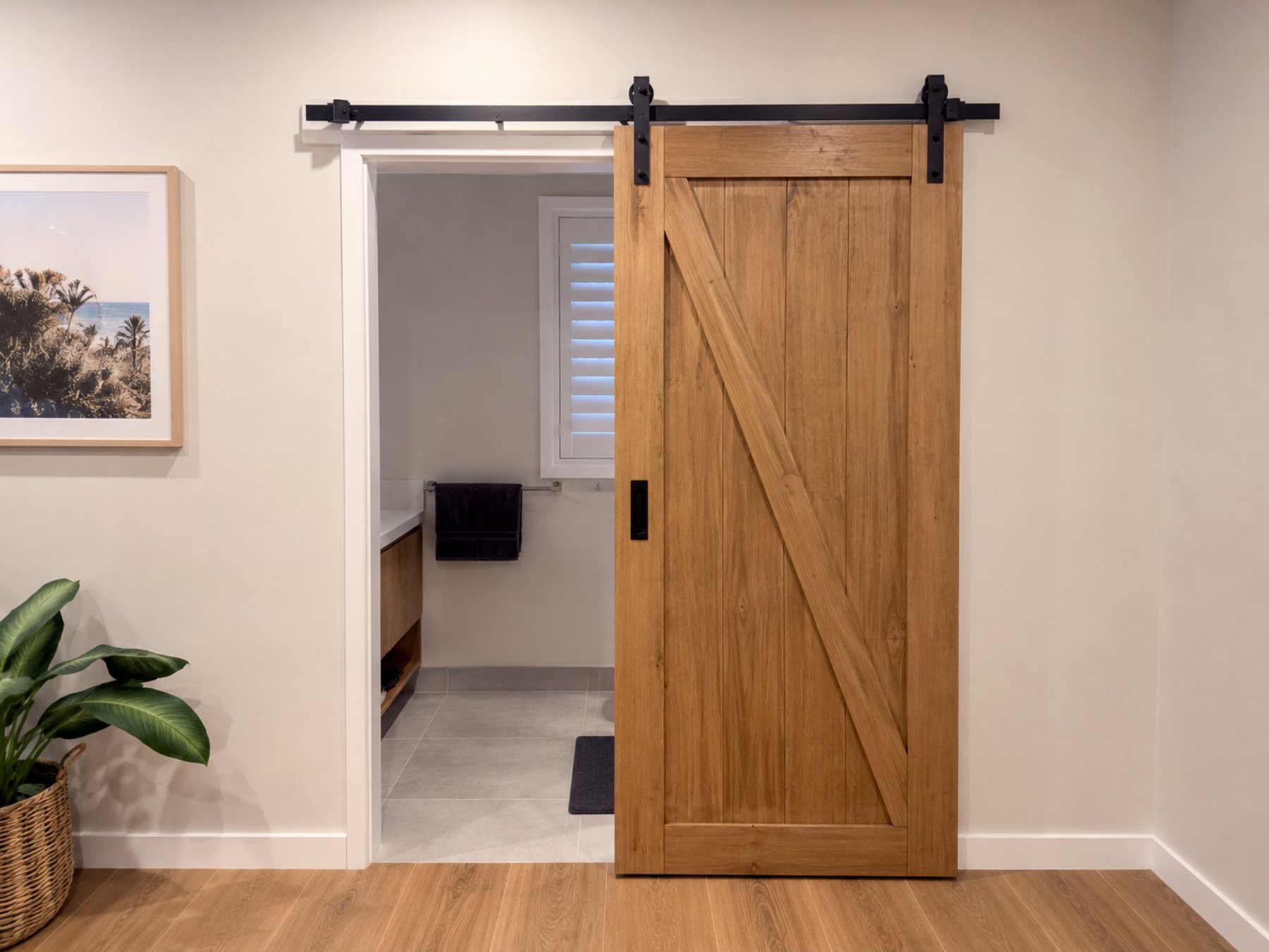 Finished timber barn door installation with black hardware