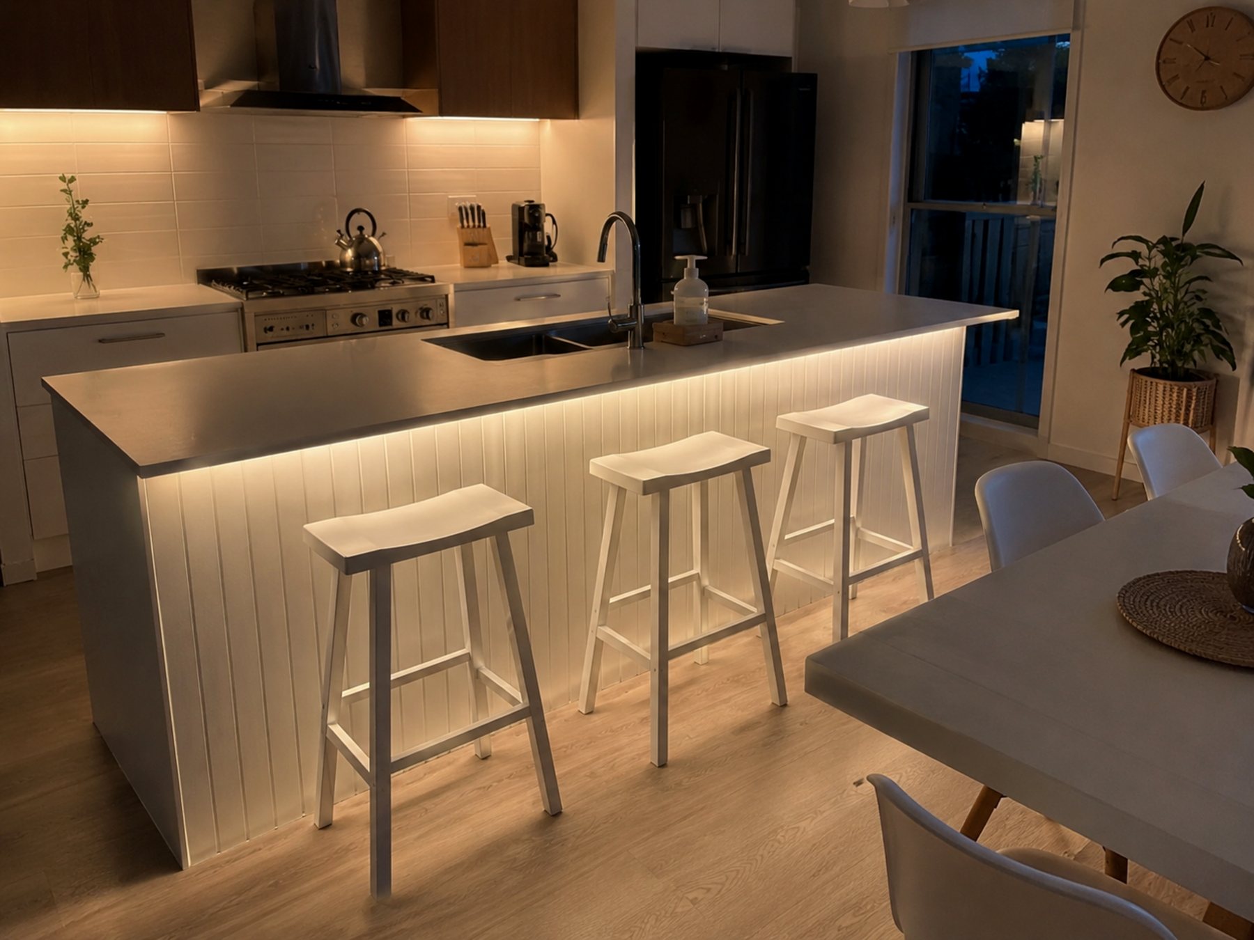 Kitchen island with lit panel and stools