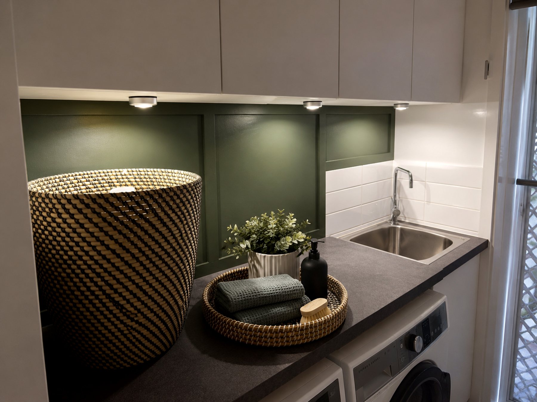 Laundry wall update with green panel, bench, sink and storage