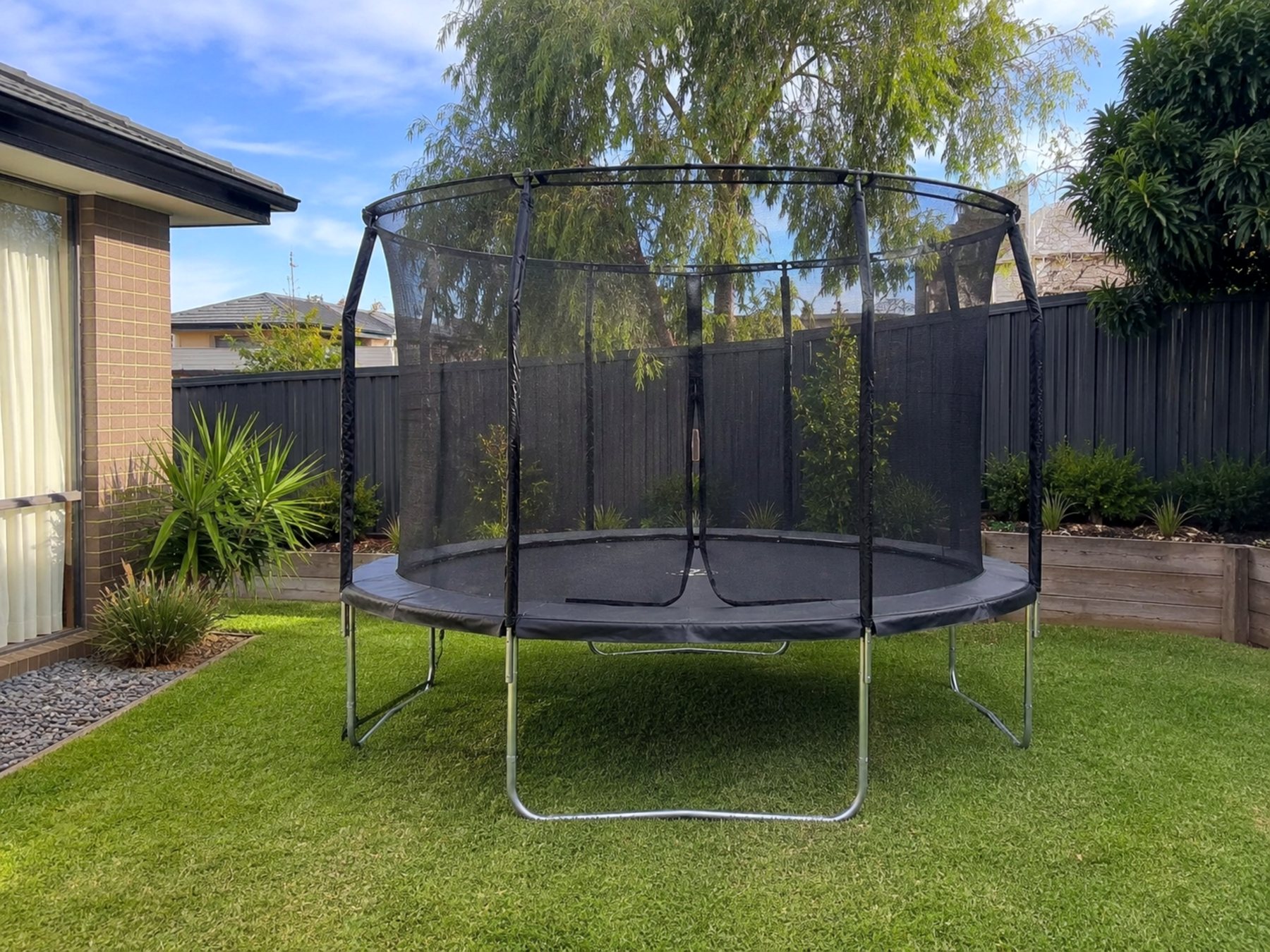 Finished backyard trampoline assembled with safety net
