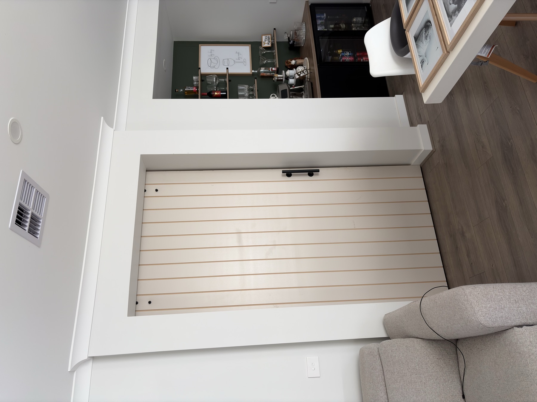 Finished barn door installation with timber panel door and black handle