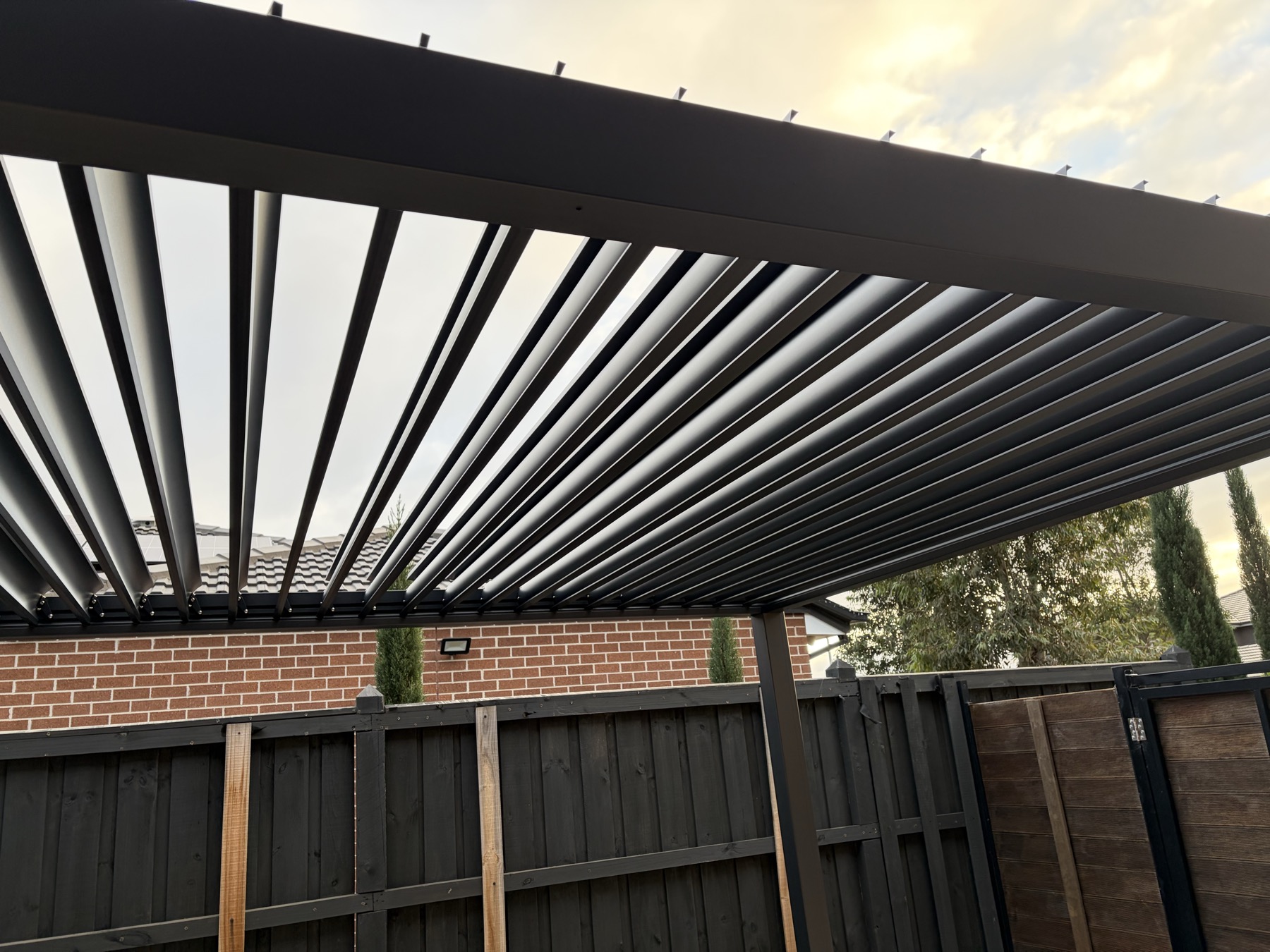 Finished pergola roof slats and frame over outdoor patio